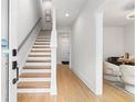 Bright hallway showcasing hardwood stairs and modern design elements leading into a comfortable seating area at 332 Gibson Street Southeast Se St, Atlanta, GA 30316