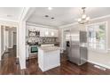Modern kitchen with stainless steel appliances, granite countertops, an island, and sleek cabinets at 1743 Thomas Ter, Decatur, GA 30032