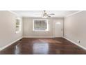 Bright living room featuring hardwood floors, white trim, neutral walls, and natural light from large windows at 1743 Thomas Ter, Decatur, GA 30032