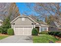 Single Gathering home with a manicured lawn, blue skies, and lovely landscaping at 4460 Cadmium Dr, Cumming, GA 30040