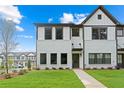 Attractive new townhome with white brick and siding exterior, green lawn, and convenient front sidewalk at 1330 Parc Bench Rd, Atlanta, GA 30316