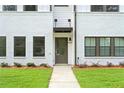 Close-up of the front door on a new townhome with white brick, dark trim, and a well-manicured lawn at 1330 Parc Bench Rd, Atlanta, GA 30316