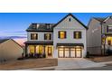 Beautifully designed two-story house featuring a brick facade, black accents, and a spacious two-car garage at 1590 Branthaven Ln, Auburn, GA 30011