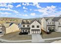 Stylish two-story home with neutral exterior, complemented by black accents and professional landscaping at 1590 Branthaven Ln, Auburn, GA 30011