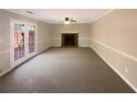 Open living room with a fireplace and French doors leading to the outside at 25 Cloud Forest Ct, Stockbridge, GA 30281
