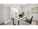 Bright office space with french doors, neutral walls, and large window perfect for working remotely at 1390 Napa Valley Sw Dr, Lawrenceville, GA 30045