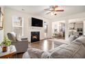 Cozy living room with a fireplace, plush seating, and a seamless flow to the dining area and kitchen at 182 Broder Farms Dr, Stockbridge, GA 30281