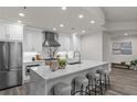 Modern kitchen featuring white cabinets, stainless steel appliances, and a marble waterfall island with seating at 270 17Th Nw St # 3905, Atlanta, GA 30363