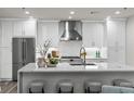 Bright kitchen with white cabinetry, stainless steel appliances, and an island with seating and modern finishes at 270 17Th Nw St # 3905, Atlanta, GA 30363