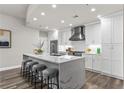 Bright kitchen with white cabinetry, stainless steel appliances, and an island with bar seating and modern finishes at 270 17Th Nw St # 3905, Atlanta, GA 30363