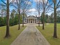 Spacious front yard with a long driveway leading up to the grand home at , Roswell, GA 30075