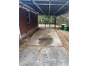 Spacious carport featuring a paved area, metal roof, and fenced-in area, offering covered parking and storage at 4300 Shady Lane Way, Forest Park, GA 30297