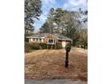 Quaint single-story brick home featuring a mailbox and a well-maintained lawn at 4300 Shady Lane Way, Forest Park, GA 30297