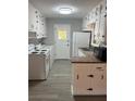 Bright kitchen features white cabinets, laminate countertops, and modern appliances at 4300 Shady Lane Way, Forest Park, GA 30297