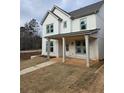 Charming two-story white home with a covered front porch and freshly laid sod at 5115 N Pratt St, Covington, GA 30014
