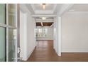 Bright foyer featuring wood floors, neutral walls, and an open view into a room with wooden ceiling beams at 2711 Twisted Oak Ne Ln, Marietta, GA 30066