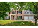 Beautiful brick home with a manicured lawn and mature trees at 5485 Brookstone Nw Dr, Acworth, GA 30101