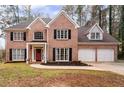 Charming brick home with a manicured lawn, mature trees and attached two-car garage at 5485 Brookstone Nw Dr, Acworth, GA 30101