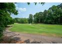 Scenic view of the golf course with lush green grass and mature trees at 5485 Brookstone Nw Dr, Acworth, GA 30101