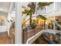 A unique interior atrium with flourishing tropical plants, balconies, and a pond at ground level at 11260 Houze Rd, Roswell, GA 30076