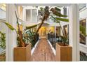 Interior atrium showcasing thriving plants, black iron railings, and abundant natural light at 11260 Houze Rd, Roswell, GA 30076
