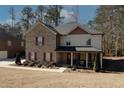 Attractive two-story home with brick and siding, offering a cozy covered front porch and manicured landscaping at 139 6Th St, Auburn, GA 30011