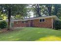 Traditional brick home featuring mature trees in a tranquil setting at 2764 Riggs Dr, Atlanta, GA 30344