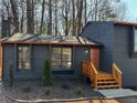 Updated exterior showcasing the home's freshly painted siding and wood-stained entryway at 1154 Stone Mill Run, Lawrenceville, GA 30046
