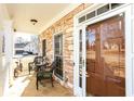 Inviting front porch with stone facade, outdoor seating, and a view of the front yard at 190 Country Club Dr, Hiram, GA 30141