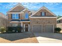 Charming two-story brick home with a well-manicured lawn and a welcoming entrance at 2045 Broadmoor Way, Fairburn, GA 30213