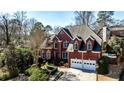 Charming two-story brick home with well-maintained landscaping and a two-car garage at 389 Mill Creek Ne Bnd, Atlanta, GA 30307