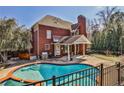 Backyard view of pool with a patio and grilling area, perfect for outdoor entertaining at 389 Mill Creek Ne Bnd, Atlanta, GA 30307