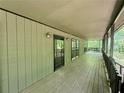 Long, covered porch featuring wood decking and a railing, providing an inviting outdoor space at 93 Mill Creek Rd, Hiram, GA 30141