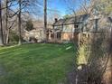 Spacious backyard with lush lawn, mature trees, and a view of the home's rear elevation at 1911 Olde Village Run, Dunwoody, GA 30338