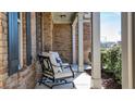 Inviting covered front porch with comfortable seating and classic white columns at 209 Providence Walk Ct, Canton, GA 30114