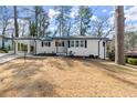 Attractive home with a carport, showcasing its well-maintained white exterior and landscaped front yard at 1937 Joseph Ct, Decatur, GA 30032