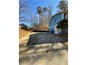 View of the backyard, featuring a house with blue siding and a patio area, ideal for outdoor enjoyment and relaxation at 3630 High Point Sw Ln, Atlanta, GA 30331