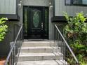 Close-up of the front door with decorative glass and secure access to the home at 3630 High Point Sw Ln, Atlanta, GA 30331