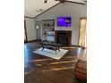 Cozy living room features vaulted ceiling, hardwood floors, fireplace, and natural light at 3630 High Point Sw Ln, Atlanta, GA 30331