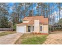 Inviting two-story home with garage, light yellow siding, and front yard at 1458 Walnut Log Pl, Austell, GA 30168