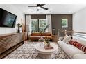 Comfortable living room with stylish furniture, a large TV, and natural light from the windows at 2537 Astaire Ct, Atlanta, GA 30318