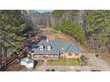Aerial view of a single-story home with a spacious driveway and lush greenery at 210 Cowan Se Rd, Conyers, GA 30094