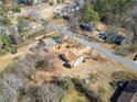 Bird's-eye view of the home, highlighting the spacious yard and surrounding trees at 303 Wood Wind Dr, Woodstock, GA 30189