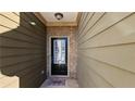 Front door with sidelight and brick facade, adding a touch of elegance to the entry at 115 Sunset Ln, Woodstock, GA 30189