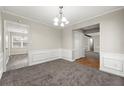 Formal dining room with wainscoting and neutral decor provides an inviting space for Gathering meals at 1876 Winding Creek Sw Ln, Marietta, GA 30064