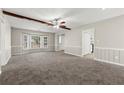 Bright living room with large bay window, plush carpeting, and stylish wainscoting at 1876 Winding Creek Sw Ln, Marietta, GA 30064