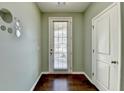 Light-filled entryway boasts hardwood floors, neutral walls, and a door leading to outdoor space at 5264 Mill Way, Stone Mountain, GA 30083