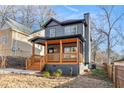 Newly renovated two-story home featuring a covered front porch with wooden pillars and rails at 2058 Detroit Nw Ave, Atlanta, GA 30314