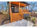 Charming covered front porch with natural wood columns and railings, leading to the front entrance at 2058 Detroit Nw Ave, Atlanta, GA 30314