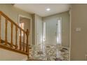Inviting entryway with decorative tile flooring and wooden staircase at 2436 Green Hollow Ct, Conyers, GA 30012